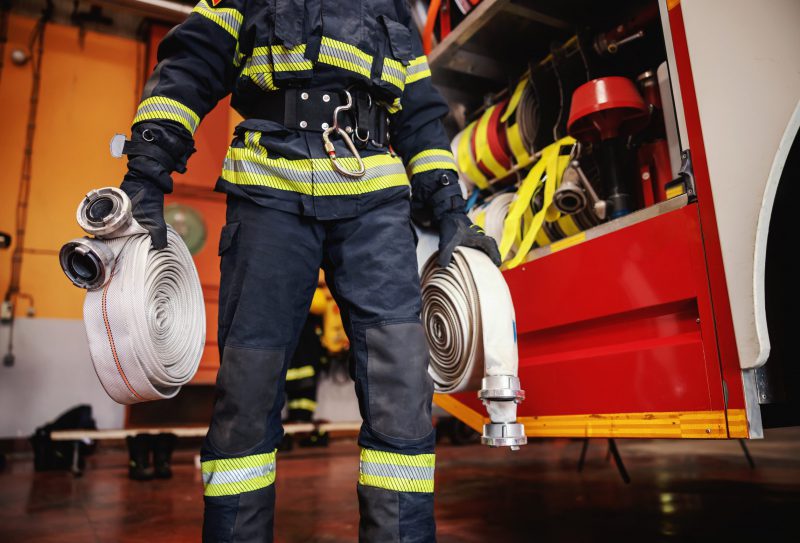 Firefighter,In,Protective,Uniform,With,Helmet,On,Head,Checking,On